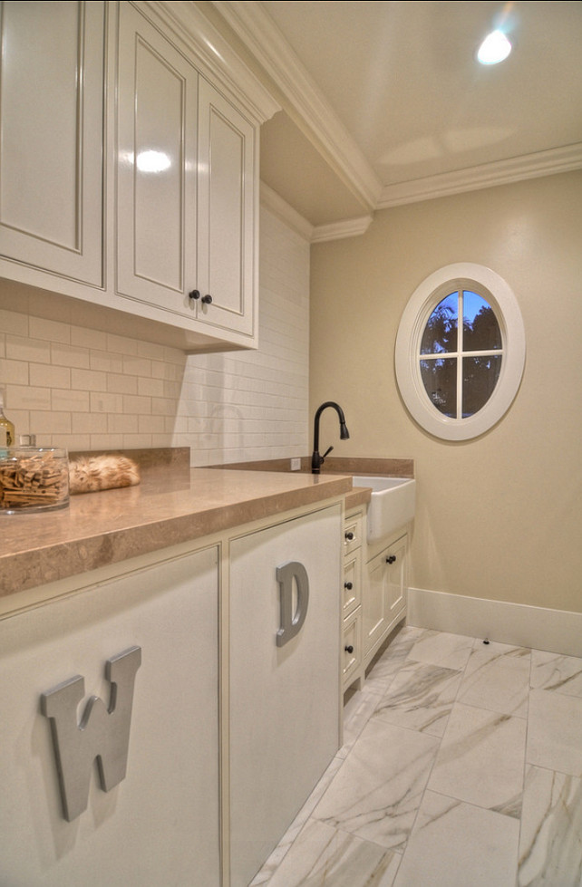 Laundry Room. Neutral laundry room with custom cabinets and plenty of storage. #LaundryRoom #LaundryRoomDesign #LaundryRoomIdeas #NeutralLaundryRoom