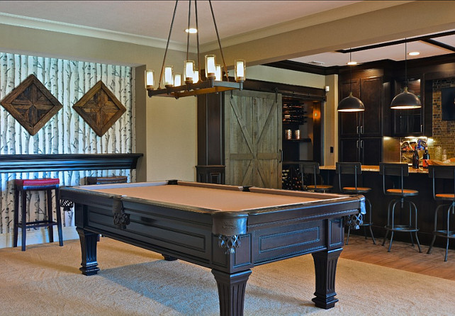 Basement Design. Great basement design. This basement is perfect for entertaining with a pool table, a theater, and seating area around the fireplace and a basement bar. #Basement #BasementIdeas