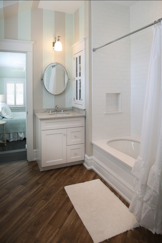 Bathroom. Bathroom Ideas. Small bathroom Ideas. This guest bathroom is on the smaller size and it's full of personality with great flooring, subway tiles and stripe painted walls. #Bathroom #BathroomIdeas #SmallBathroom