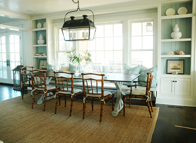 Dining Room. Turquoise Dining Room with Banquette. Cottage dining room built-in cabinets with turquoise blue beadboard backsplash and beachy accents. Built-in dining room banquette, wicker dining chairs and blue banquette pillows. Dining Room Ideas. Morrison Fairfax Interiors