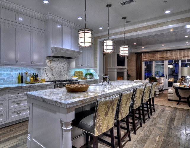 Kitchen. Kitchen Ideas. White Coastal Kitchen Design. Pendant Lighting are from Visual Comfort. Ikat fabric on the back of the stool is the "Kelly Wearstler Bengal Bazaar in Murshroom/Straw GWF-2811-614 for Lee Jofa".#Kitchen #CoastalKitchen #KitchenDesign
