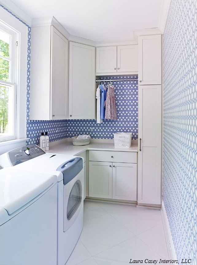 Laura Casey Interiors. Laundry Room. Laundry room with washer and dyer below window beside off-white shaker cabinets accented with brushed nickel pulls and off-white counters below a tension rod drying rack framed by David Hicks Hex Wallpaper over diamond laid floor tile. #LaundryRoom #LaundryRoomDesign #LaundryRoomIdeas