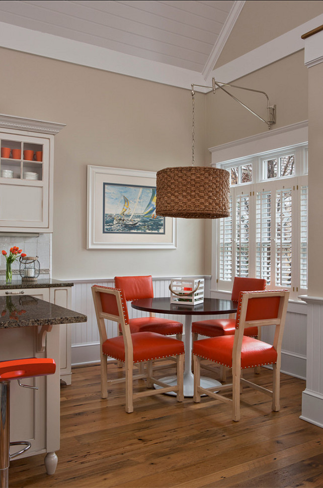 Transitional Interiors. Transitional eacting nook with hints of orange decor. #TransitionalInteriors #OrangeInteriors Designed by Cottage Company Interiors.
