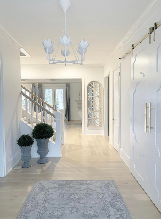 https://www.homebunch.com/wp-content/uploads/2021/09/French-country-style-Foyer-featuring-French-country-style-wall-mirror-white-barn-doors-French-country-style-interiors-1.jpg