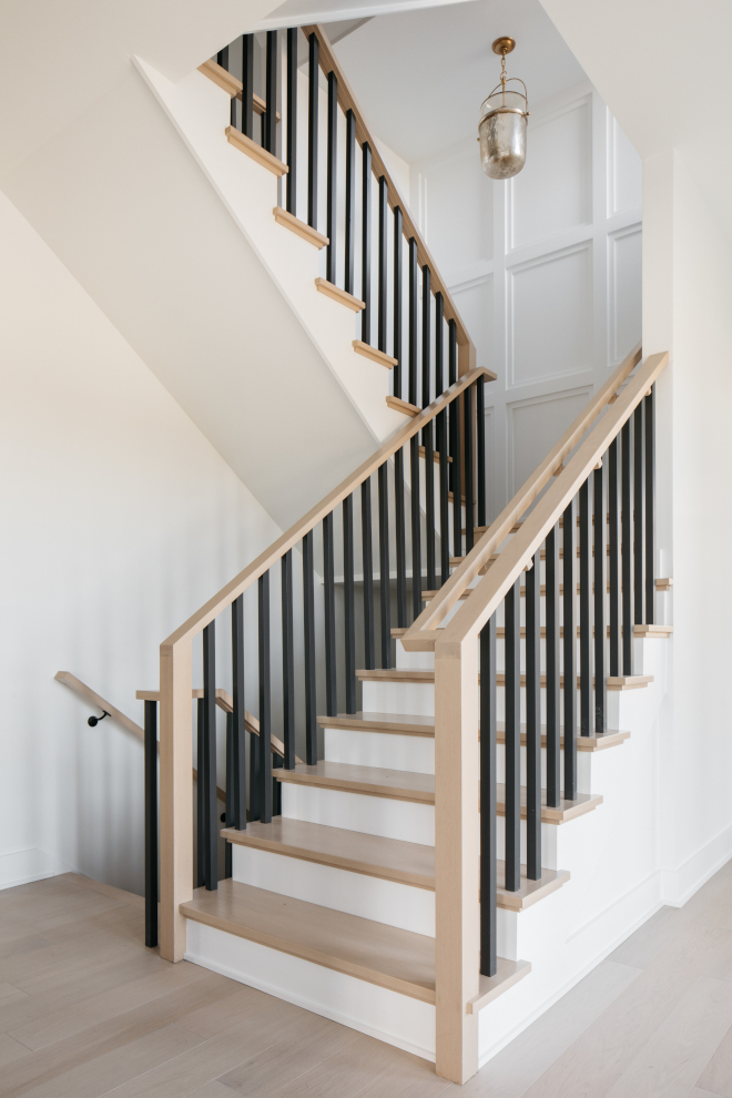 https://www.homebunch.com/wp-content/uploads/2022/04/Staircase-combination-of-light-wood-black-balusters-and-the-classic-white-paint-color.jpg