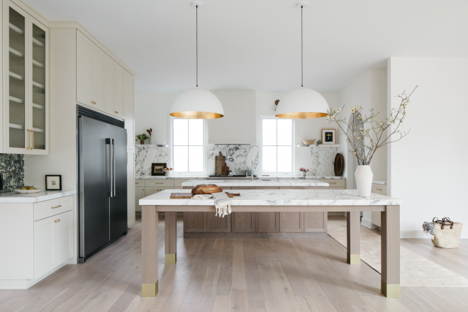 In the kitchen double islands in White Oak create a separation from food prep and one for dining while creamy white cabinets complement and warm up the entire space #kitchen #doubleislands #WhiteOak #dining #creamywhitecabinet
