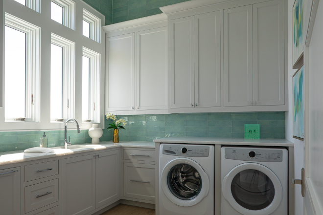 The green backsplash tile adds a splash of color and freshness to this laundry room #greenbacksplash #tile #laundryroom