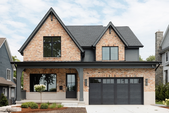 This new-construction home is a new take on classic brick exterior that invites you to spend some time on the dreamy front porch #newconstruction #brick #exterior #newclassic #frontporch