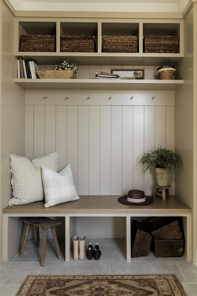 A comforting earth-toned mudroom locker its backdrop a charming display of shiplap ready to welcome you home