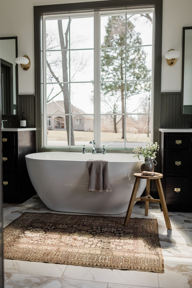 Soft hues of beige brown and green mimic the tones of the forest while materials like stone and wood introduce an organic feel to the space #bathroom #organic