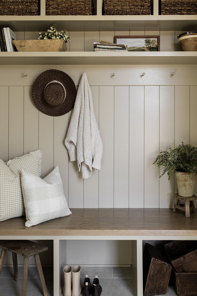 A neutral beige mudroom locker adorned with a shiplap backdrop #neutral #beige #mudroom #locker #shiplapbackdrop