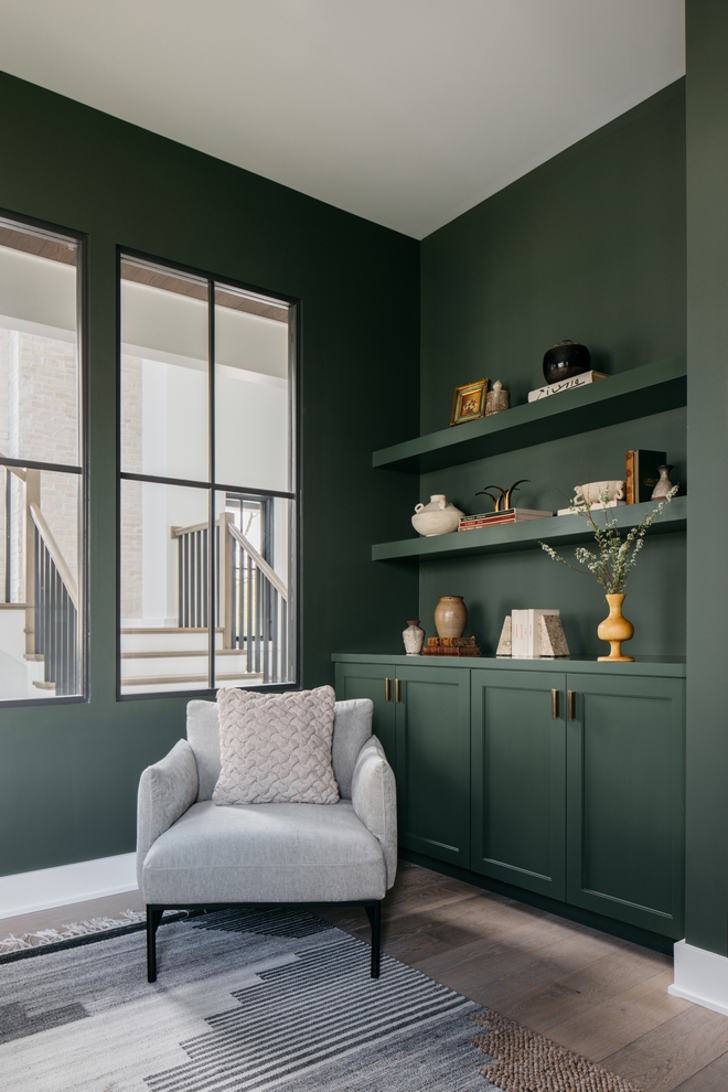 The deep rich green hue of Benjamin Moore Vintage Vogue adds an element of timeless elegance, while the white trims offer a refreshing contrast that brightens the room Natural light filters through the interior windows #BenjaminMooreVintageVogue