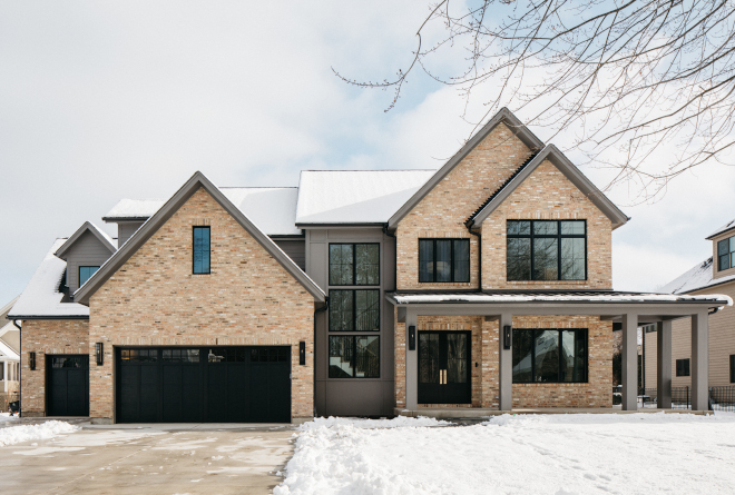 New-construction Architecture Design Ideas Peaked roof lines and black windows are complemented by a combination of brick board and batten and lap siding #Newconstruction #ArchitectureDesignIdeas #Peakedroof #blackwindows #brick #boardandbatten #lapsiding