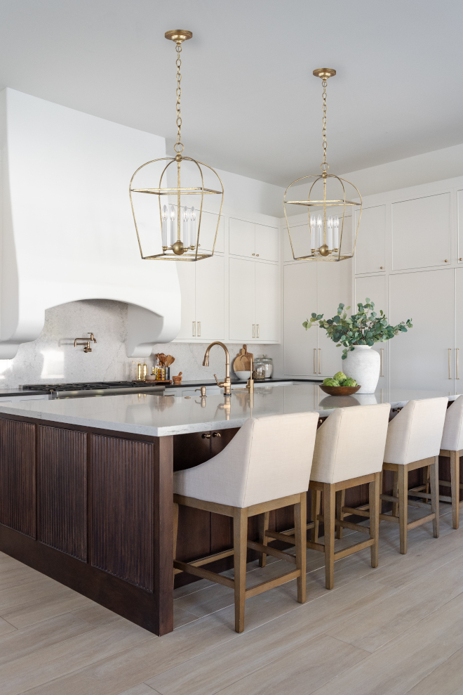 The stunning curved plaster range hood combined with a kitchen island adorned with reeded detailing adds an abundance of charm and elegance to this newly renovated kitchen #curvedhood #plasterrangehood #kitchen #island #reeded #newlyrenovated #kitchen #newlyrenovatedkitchen