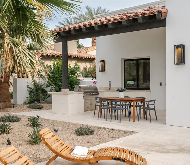 Outdoor kitchen The covered limestone patio features a built-in BBQ and sink while the yard is enhanced with an outdoor shower area #outdoorkitchen