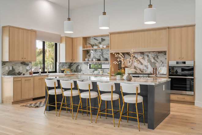 The spacious kitchen island accommodates five people and features a prep sink along with an additional dishwasher #kitchenisland #kitche #island