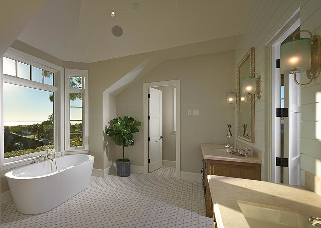 Bathroom. A contemporary freestanding tub stands in the foreground paired with a mounted tub filler