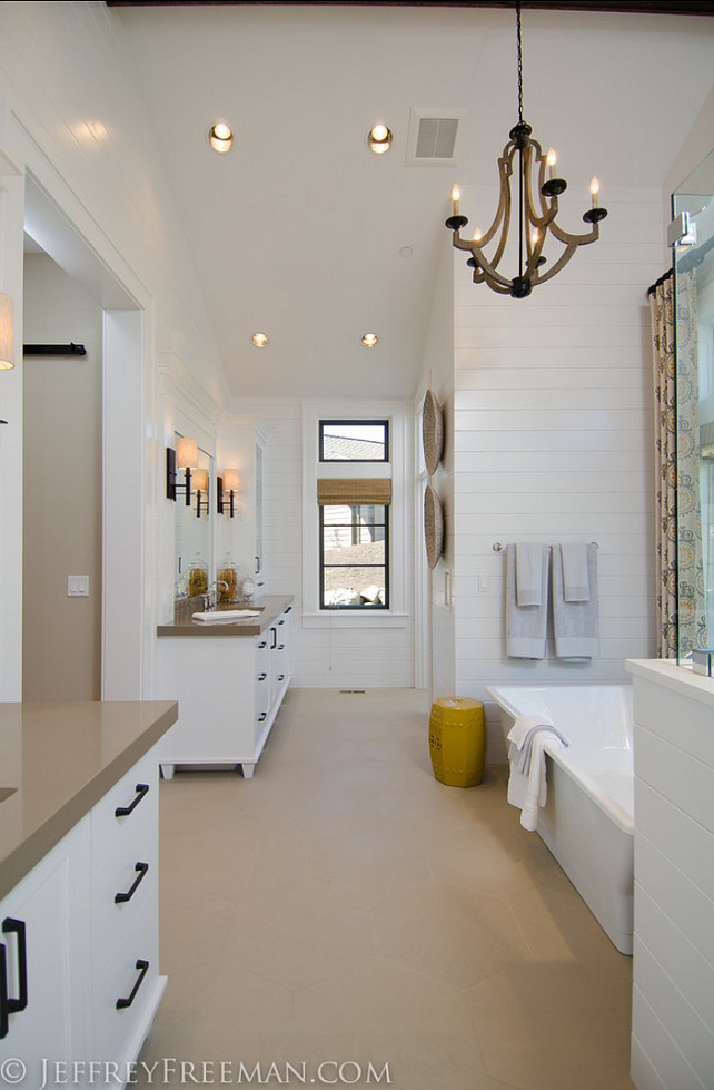 Bathroom. The vaulted bathroom has beautiful hanging chandelier, the walls are covered in painted tongue and groove cedar paneling. #Bathroom