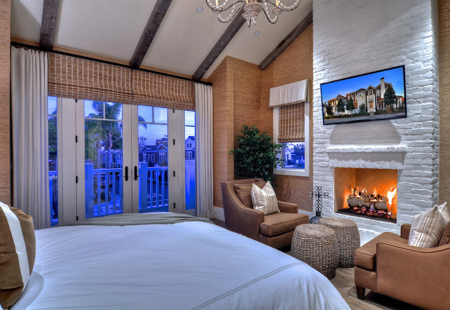 Bedroom Decor. Bedroom Decor Ideas. A variety of textures and warm tones create a relaxing feel in this bedroom. Two upholstered chairs sit in front of the white painted brick fireplace, a perfect place to rest and rejuvenate