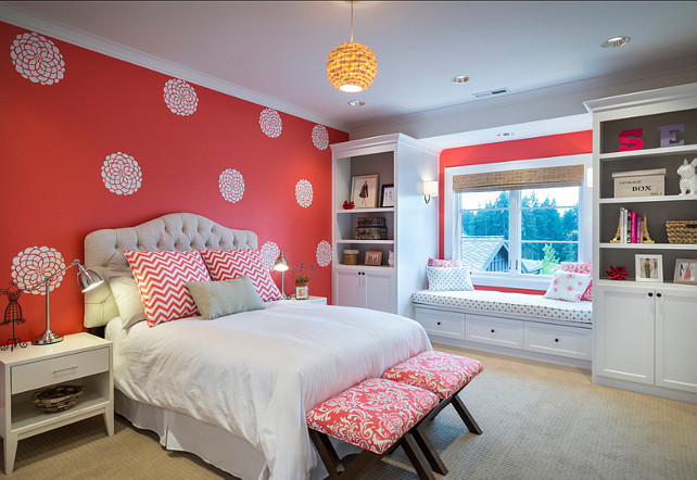 Bedroom. Kids Bedroom Ideas. Kids Bedroom with stencilled walls. Girls bedroom features painted coral walls, custom tufted headboard, custom x benches, nightstands, custom painted bookshelves, window seat with bench, woven roman shades, Etsy Dahlia wall decals. #Bedroom #KidsBedroom