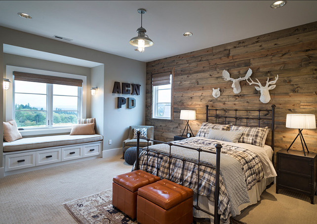Bedroom. Rustic Bedroom Design. Bedroom with reclaimed barnwood. The boys bedroom features white animal heads, barn wood paneling, hanging light, metal side tables, tripod lamps, storage cubes, metal letters, built in window seat and plaid bedding. #Barnwood #ReclaimedBarnwood