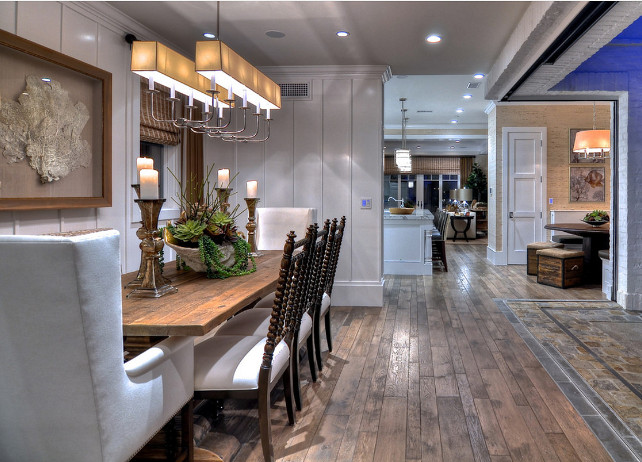 Dining Area. Dining Area Design. Wire brushed wood flooring is contrasted with bright white walls and detailed finished carpentry. Accents of gold, brown and gray finish the look. Lighting is the "E.F. Chapman Branched 10 Light Linear Pendant in Polished Nickel with Long Natural Paper Shade SL5863PN-NP2" #DiningArea .