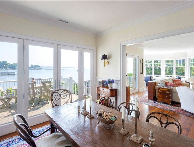 Dining Room and Kitchen Design Ideas. Beautiful dining room with coastal decor, antique farmhouse table and white kitchen on the back. #Kitchen #DiningRoom #AntiqueFurniture #FamrhouseTable Via Sotheby's Homes.