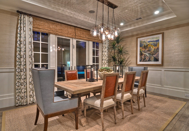 Dining Room. Coastal Dining Room. The bubble lamp chandelier placed over a natural wood dining table, surrounded by upholstered dining chairs, invites guests to relax while dining in this monochromatic space. #DiningRoom