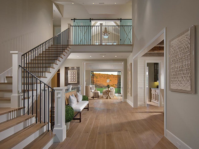 Foyer. Foyer Ideas. Beautiful coastal inspired foyer. Note the office on the second floor with turquoise barn doors. #Foyer #Coastal #CoastalHomes