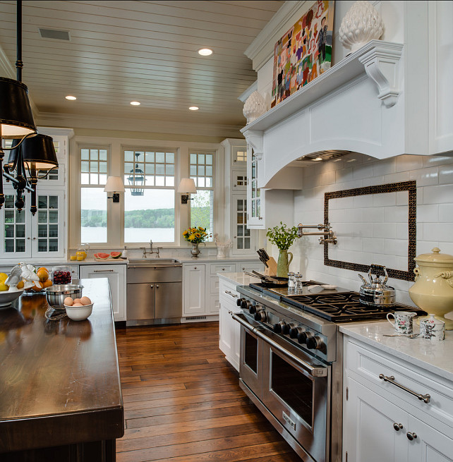 Kitchen Countertop. Kitchen Countertop Ideas. The perimeter countertop in this traditional kitchen is white marble and the countertop on the island is a thick butcher's block. #Kitchen #KitchenCountertop