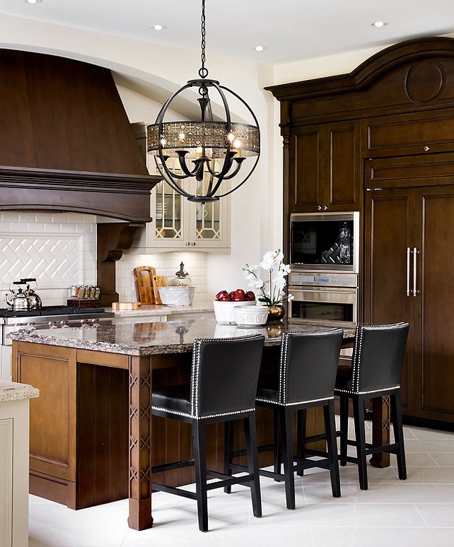 Kitchen Design Ideas. French Kitchen. Great dark stained kitchen cabinets with arches and cabinet trim details. Light Fixture above island is the "Eurofase 19368-016 Arsenal 5-Light Chandelier". #OrnateKitchenDesign #FrenchKitchen #Kitchen Designed by Jane Lockhart.