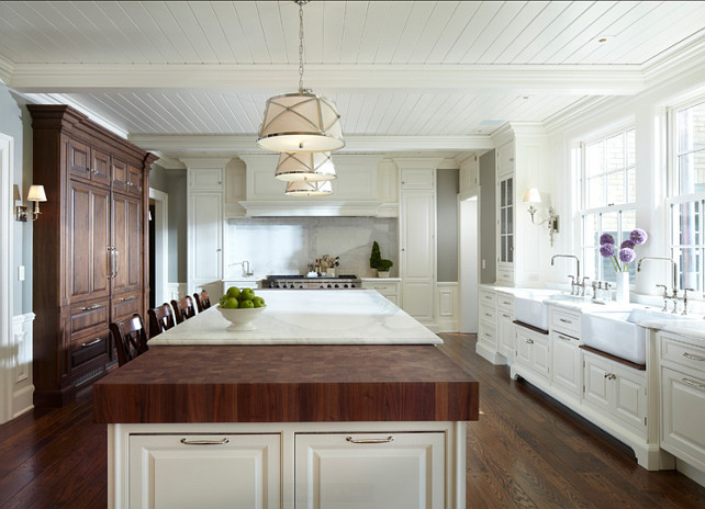 Kitchen with large island with marble and butcher block countertop. The butcher block is made of walnut. This kitchen also feautures beadboard ceilings. #Kitchen #KitchenDesign #KitchenIdeas #KitchenIsland Designed by Yunker Associates Architecture.