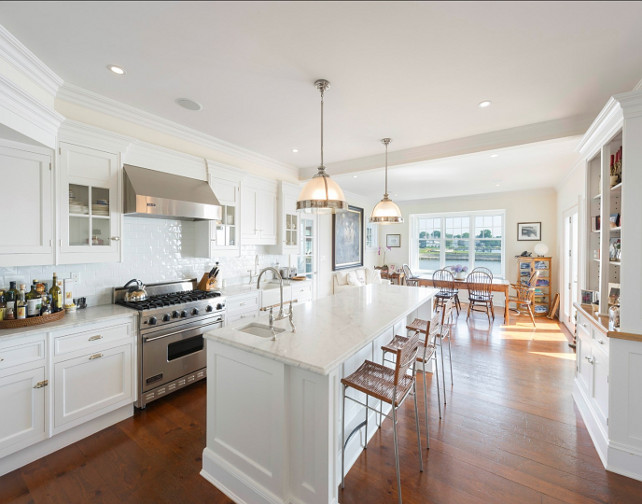 Kitchen. Kitchen Design Ideas. White Kitchen with white marble countertop and double pendants above island. #Kitchen #WhiteKitchen #ClassicKitchen #KitchenIdeas #CoastalKitchen #WhiteMarbleCountertop Via Sotheby's Homes.