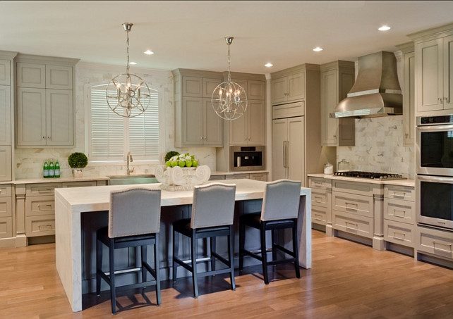 Kitchen. Kitchen with gray cabinets, white marble marble countertop, gray island and hardwood flooring. #kitchen #GrayKitchen