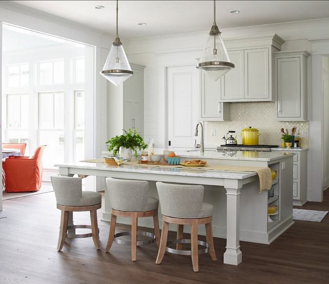 Kitchen. Pale Gray Kitchen. Transitional Kitchen with pale gray cabinets. The kitchen feature pale gray cabinets with clean lines and transitional lighting.  Pendants are the "Thomas O'Brien - Gale Pendant" by Circa Lighting.  The swiveling barstools are from Lee Industries.  The MotionSense faucet is by Moen. #Kitchen #KitchenIdeas #GrayKitchen #KitchenCabinets #TransitionalKitchen #KitchenDesign