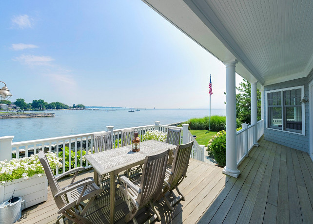 Patio Decor Ideas. Beautiful ocean front patio with coastal inspired decor. Teak Patio Furniture.  Deck is made of natural mahogany. Mahogany might not be the cheapest choice for decking, but it is extremely durable and beautiful, not to mention that mahogany is practically splinter free - a plus if you like to walk barefoot on the deck or have small children. #Patio #PatioDecorIdeas #TeakPatioFurniture Via Sotheby's Homes.