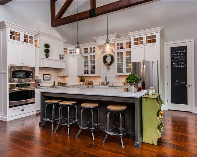 Transitional Kitchen Design. Transitional kitchen with beamed ceiling, hardwood floors, large kitchen island and chalk board paint. #Kitchen #TransitionalKitchen Tolaris Homes.