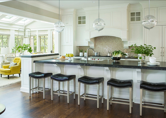 White Kitchen Ideas. White Kitchen design with inspiring ideas. The countertops in this white kitchen are honed Via Lattea granite. Kitchen Pendants are "Janus globe pendant from Cyan Design". #WhiteKitchen #WhiteKitchenIdeas #WhiteKitchenDesign