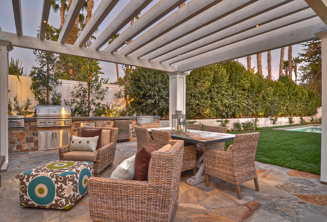 outdoor living. Comfortable outdoor furniture next to the swimming pool invites guests to enjoy life outdoors. The built in barbecue with rock wall detailing makes this space ideal for entertaining. #OutdoorSpaces